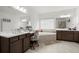 Bright bathroom with double sinks, a large mirror, and a soaking tub at 4205 Madison Hall Dr, Cumming, GA 30028