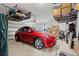 Spacious garage featuring storage racks and a vibrant red Tesla car at 4205 Madison Hall Dr., Cumming, GA 30028