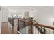 Hallway with hardwood floors, a wooden railing, and views of the neighborhood at 4205 Madison Hall Dr, Cumming, GA 30028