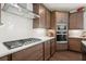 Close-up of the kitchen featuring stainless steel appliances and white subway tile backsplash at 4205 Madison Hall Dr, Cumming, GA 30028