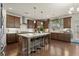 Modern kitchen features a large central island with seating, stainless steel appliances, and ample storage at 4205 Madison Hall Dr, Cumming, GA 30028