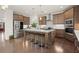 Beautiful kitchen with stainless steel appliances, large central island with seating, and hardwood floors at 4205 Madison Hall Dr, Cumming, GA 30028