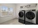Bright laundry room with modern washer and dryer and ample sunlight at 4205 Madison Hall Dr, Cumming, GA 30028