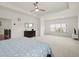 Bright main bedroom featuring tray ceiling, ceiling fan, and an abundance of natural light at 4205 Madison Hall Dr, Cumming, GA 30028