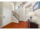 Spacious foyer features hardwood floors, a staircase with iron spindles, and stylish lighting at 540 Roland Manor Dr, Dacula, GA 30019