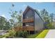 Modern two-story home featuring a contemporary design, wooden balconies, and a well-maintained yard at 1792 Charles Pl Nw, Atlanta, GA 30318