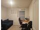 Functional bedroom with a desk, comfy sofa, carpeted floors, and decor at 623 Wayland Ct, Fairburn, GA 30213