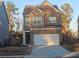 Charming two-story home with a brick and stone facade and an attached two-car garage at 623 Wayland Ct, Fairburn, GA 30213