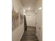 Hallway featuring wood floors, white trim, and accent paintings adding character at 623 Wayland Ct, Fairburn, GA 30213