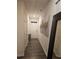 Inviting hallway with hardwood floors, neutral walls, and decorative artwork at 623 Wayland Ct, Fairburn, GA 30213