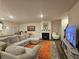 Spacious living room with fireplace, kitchen view, and comfortable seating area at 623 Wayland Ct, Fairburn, GA 30213