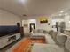Open-concept living space with a large sofa, modern decor and seamless flow to the kitchen at 623 Wayland Ct, Fairburn, GA 30213