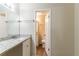 Well-lit bathroom with a white vanity, granite countertop, and a large mirror above the sink at 2370 Wingfoot Pl, Decatur, GA 30035