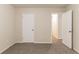 Neutral bedroom with carpet, featuring a closet and view into hallway with wood-look vinyl plank at 2370 Wingfoot Pl, Decatur, GA 30035