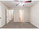 Spacious bedroom with neutral walls, plush carpet, and a ceiling fan with lighting at 2370 Wingfoot Pl, Decatur, GA 30035