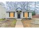 Charming home featuring a gray exterior, black shutters and a well-maintained lawn at 2370 Wingfoot Pl, Decatur, GA 30035