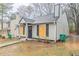Charming home featuring a gray exterior, black shutters and a well-maintained lawn at 2370 Wingfoot Pl, Decatur, GA 30035
