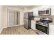 Modern kitchen featuring stainless steel appliances and ample cabinet space at 2370 Wingfoot Pl, Decatur, GA 30035