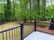 Black metal fence overlooks the backyard and surrounding mature trees creating a private outdoor space at 2899 Tejas Sw Trl, Atlanta, GA 30331