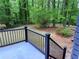 Black metal fence overlooks the backyard and surrounding mature trees creating a private outdoor space at 2899 Tejas Sw Trl, Atlanta, GA 30331