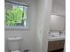Elegant bathroom featuring a stylish vanity with double sinks, modern fixtures, and a view from the window at 2899 Tejas Sw Trl, Atlanta, GA 30331