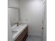 Modern bathroom featuring double sinks, sleek cabinetry, elegant finishes, and a well-lit mirror at 2899 Tejas Sw Trl, Atlanta, GA 30331