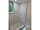 Modern bathroom showing walk-in shower with white tile and contrasting black trim at 2899 Tejas Sw Trl, Atlanta, GA 30331