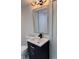 Bathroom vanity with modern dark cabinets, a light countertop, and a gray framed mirror at 2899 Tejas Sw Trl, Atlanta, GA 30331