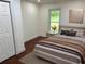 Cozy bedroom featuring hardwood floors, a plush bed, and a window view at 2899 Tejas Sw Trl, Atlanta, GA 30331