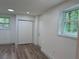 Well-lit bedroom with modern wood floors, a closet, and a window providing natural light at 2899 Tejas Sw Trl, Atlanta, GA 30331