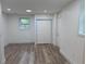Well-lit bedroom with modern wood floors, a closet, and a window providing natural light at 2899 Tejas Sw Trl, Atlanta, GA 30331