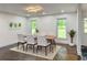 Bright dining room with modern lighting and large windows, ideal for Gathering gatherings at 2899 Tejas Sw Trl, Atlanta, GA 30331