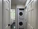 Hallway with in-unit laundry, storage and access to a bathroom with a modern vanity at 2899 Tejas Sw Trl, Atlanta, GA 30331