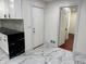 Stylish kitchen featuring marble floors and sleek black countertops at 2899 Tejas Sw Trl, Atlanta, GA 30331
