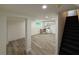 Basement living area has wood floors, a kitchenette, and black stairs to the upper level at 2899 Tejas Sw Trl, Atlanta, GA 30331