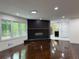 Living room featuring a modern fireplace, hardwood floors and ample natural light at 2899 Tejas Sw Trl, Atlanta, GA 30331