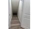 Unique storage space under the stairs featuring modern wood floors and painted white walls at 2899 Tejas Sw Trl, Atlanta, GA 30331