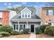 Charming townhouse featuring a cozy front porch and well-maintained landscaping at 5024 Bell Se Dr, Smyrna, GA 30080