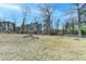Large back yard featuring mature trees at 161 Muddy River Rd, Lawrenceville, GA 30043