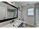 Bright bathroom featuring stylish vanity with dark wood framed mirror and decorative tile accents at 161 Muddy River Rd, Lawrenceville, GA 30043