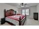 Bedroom features a decorative bed, ceiling fan, and large window at 161 Muddy River Rd, Lawrenceville, GA 30043