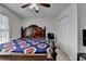 Cozy bedroom features a ceiling fan, large bed, and a closet at 161 Muddy River Rd, Lawrenceville, GA 30043