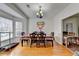 Light-filled dining room features hardwood floors, modern chandelier, and a large bay window at 161 Muddy River Rd, Lawrenceville, GA 30043