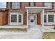Brick home's front entry features detailed portico, columns, and sidelights framing the front door at 161 Muddy River Rd, Lawrenceville, GA 30043