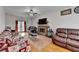 Inviting living room featuring a brick fireplace, hardwood floors, and ceiling fan at 161 Muddy River Rd, Lawrenceville, GA 30043