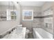 Bathroom with marble vanity, mosaic tile accents, and natural light at 2923 Hall Se Dr, Smyrna, GA 30082
