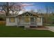 Charming home featuring a covered front porch, manicured lawn, and neutral exterior color scheme at dusk at 2923 Hall Se Dr, Smyrna, GA 30082