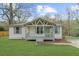 Charming home featuring a covered front porch, manicured lawn, and neutral exterior color scheme at 2923 Hall Se Dr, Smyrna, GA 30082