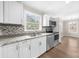 Bright kitchen featuring white cabinets, stainless steel appliances, herringbone backsplash, and granite countertops at 2923 Hall Se Dr, Smyrna, GA 30082