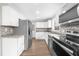 Bright kitchen featuring white cabinets, stainless steel appliances, herringbone backsplash, and granite countertops at 2923 Hall Se Dr, Smyrna, GA 30082